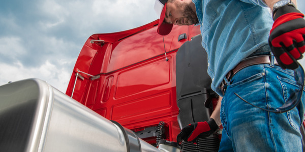 Truck driver fueling truck